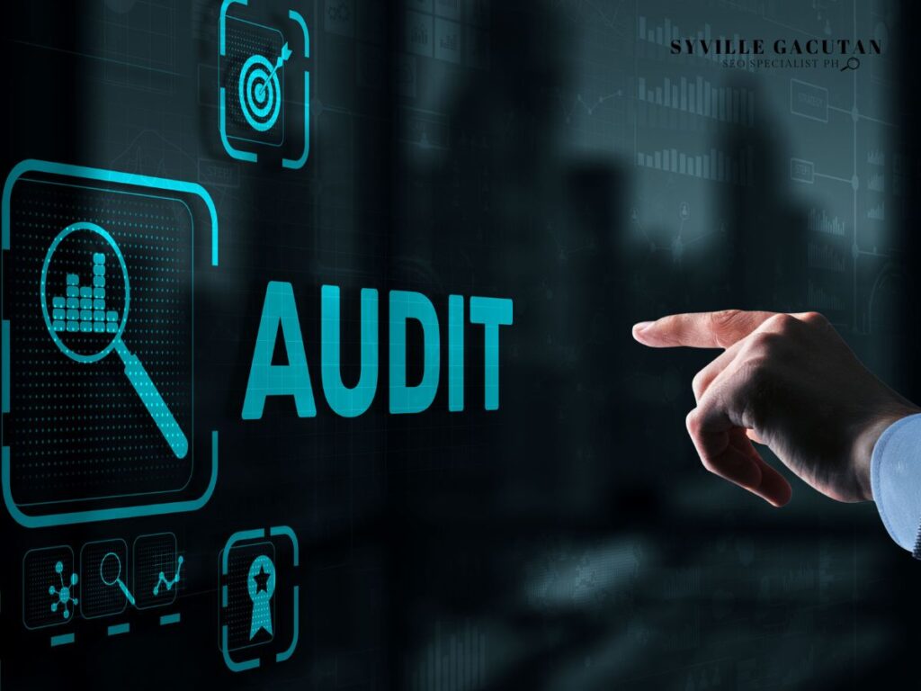 Finger pointing to "Audit" icon on a digital dashboard.