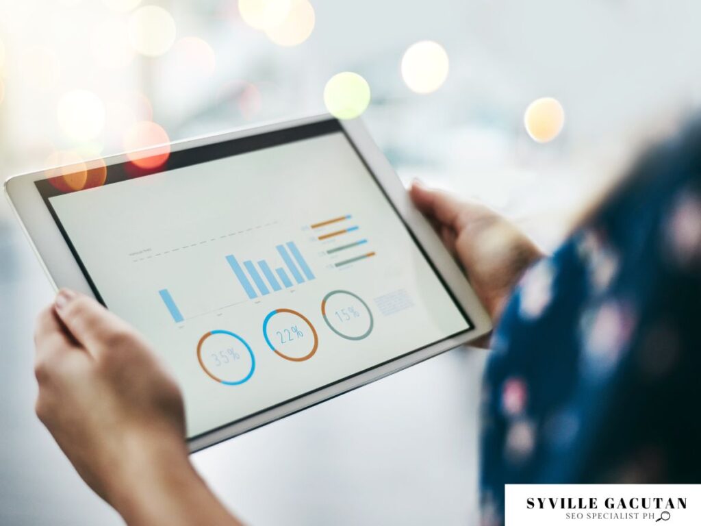  Person holding a tablet with digital graphs and analytics charts.