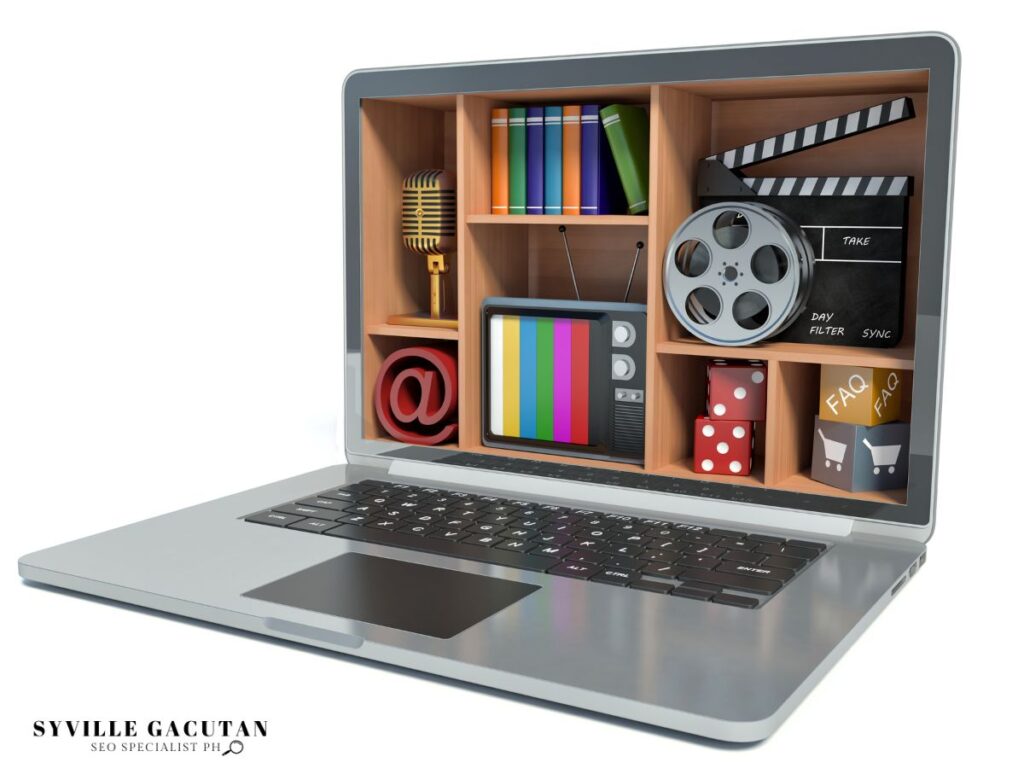 Laptop display showing multimedia shelf with TV, microphone, film reel, and @ symbol.