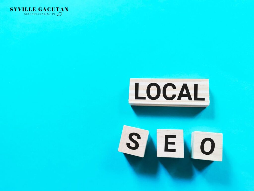 Wooden blocks spelling 'LOCAL SEO' on a bright blue background.