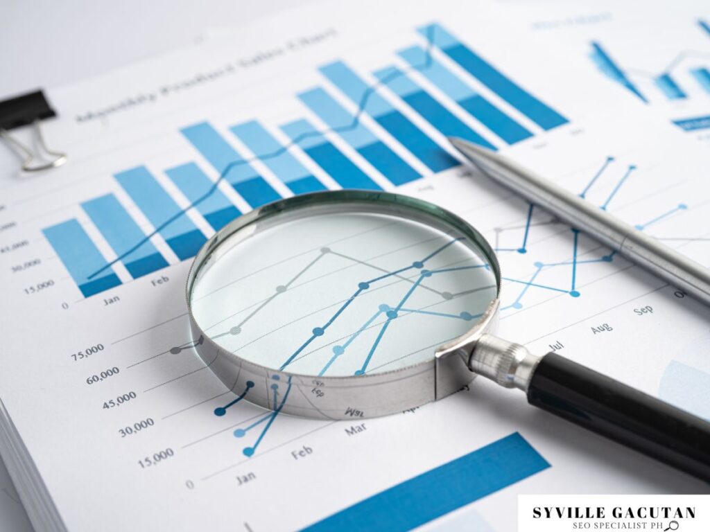Magnifying glass over analytical graphs and data report papers.