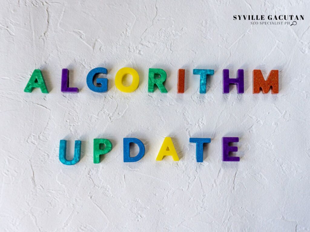 Colorful magnetic letters spelling "ALGORITHM UPDATE" on white textured wall surface.