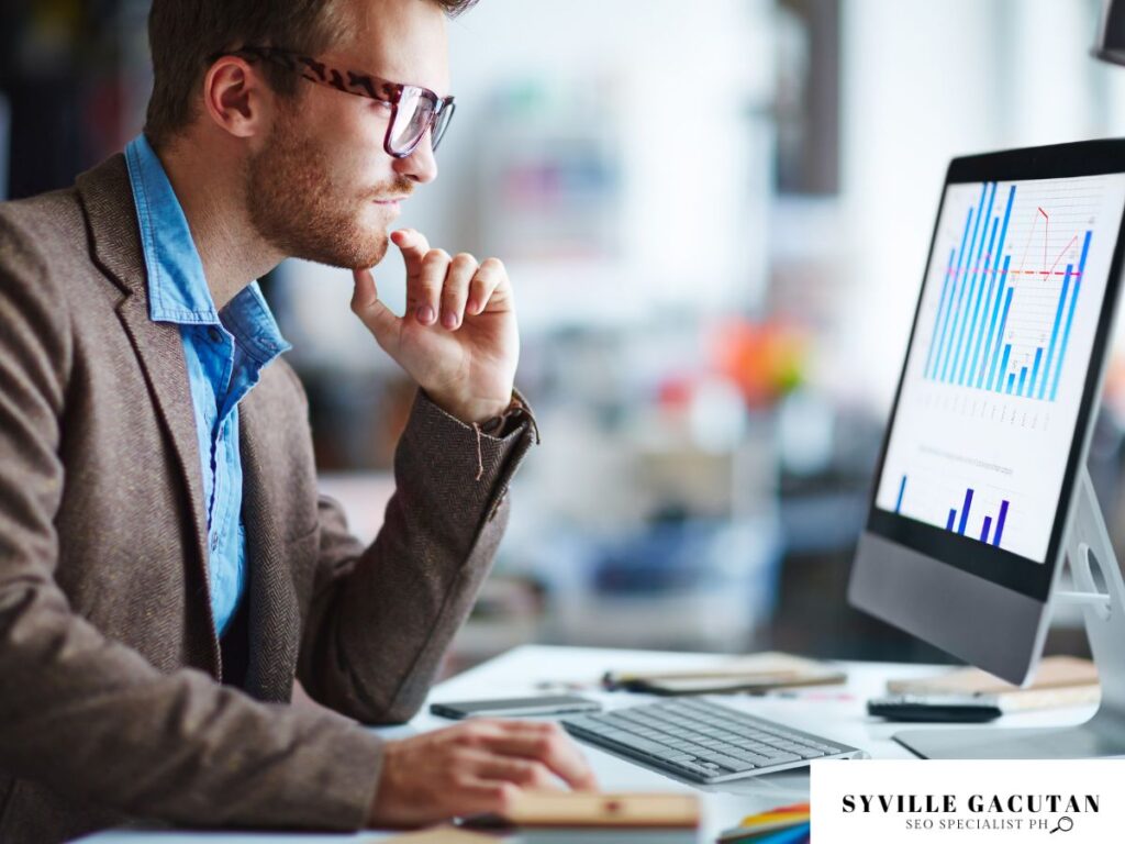 Person analyzing graphs on a computer screen.