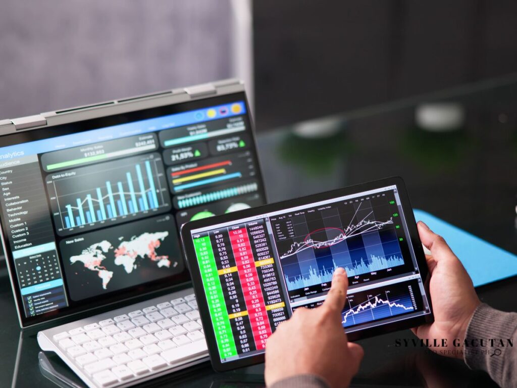 Analyzing interactive charts on a tablet with laptop screens.