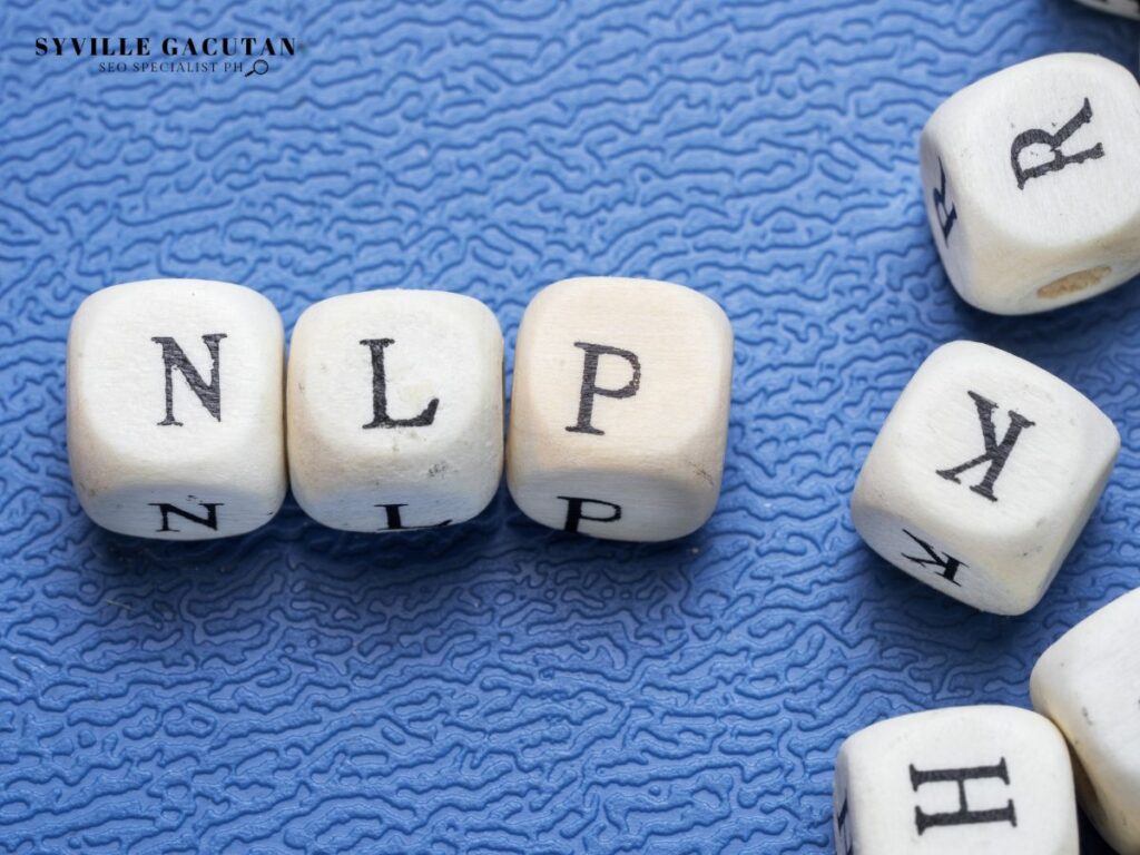 White letter dice spelling "NLP" on textured blue background with scattered letter cubes.