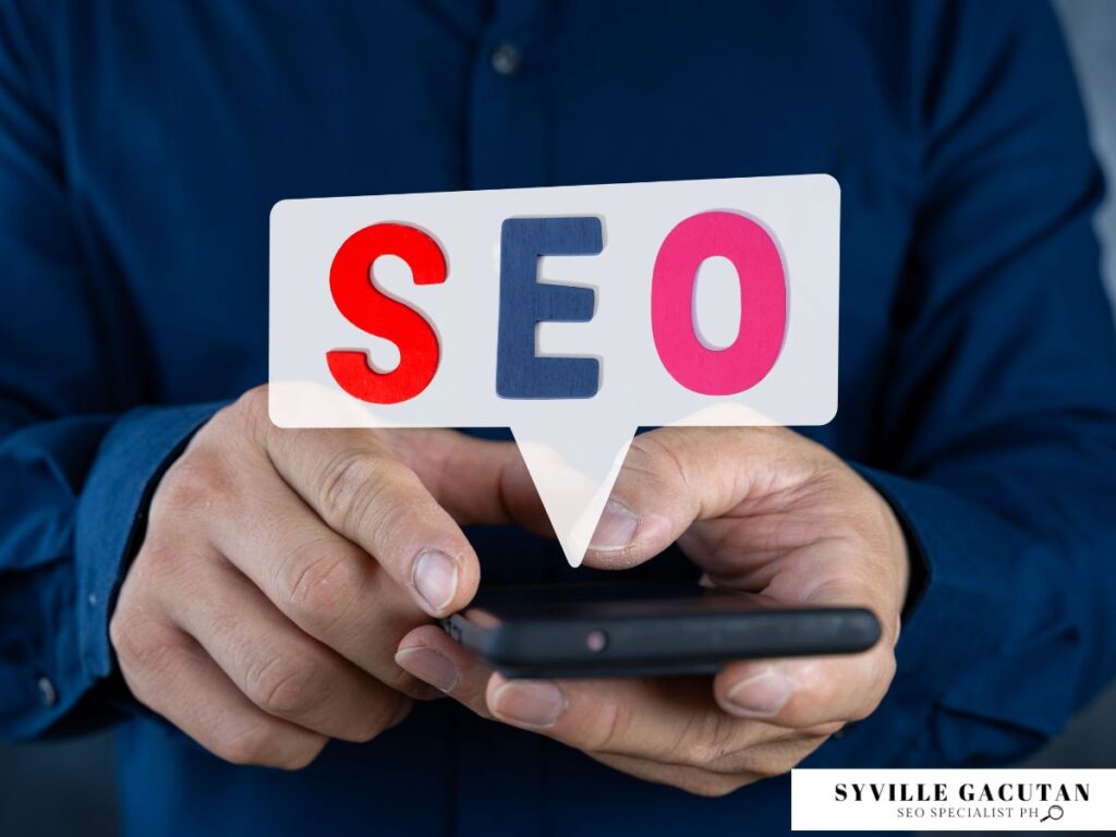 Close-up of hands with 'SEO' text in speech bubble on phone.