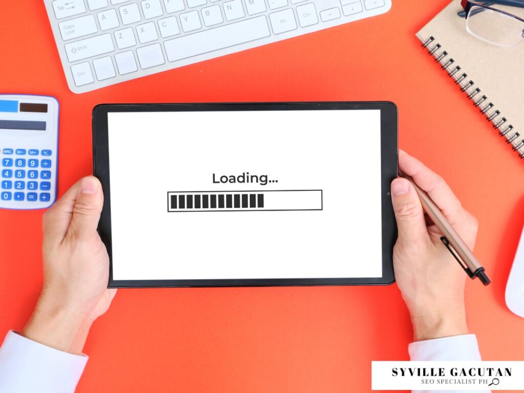 Tablet screen showing 'Loading...' bar held over a red workspace.