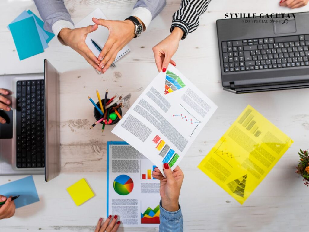 Multiple hands exchanging documents with charts and data.
