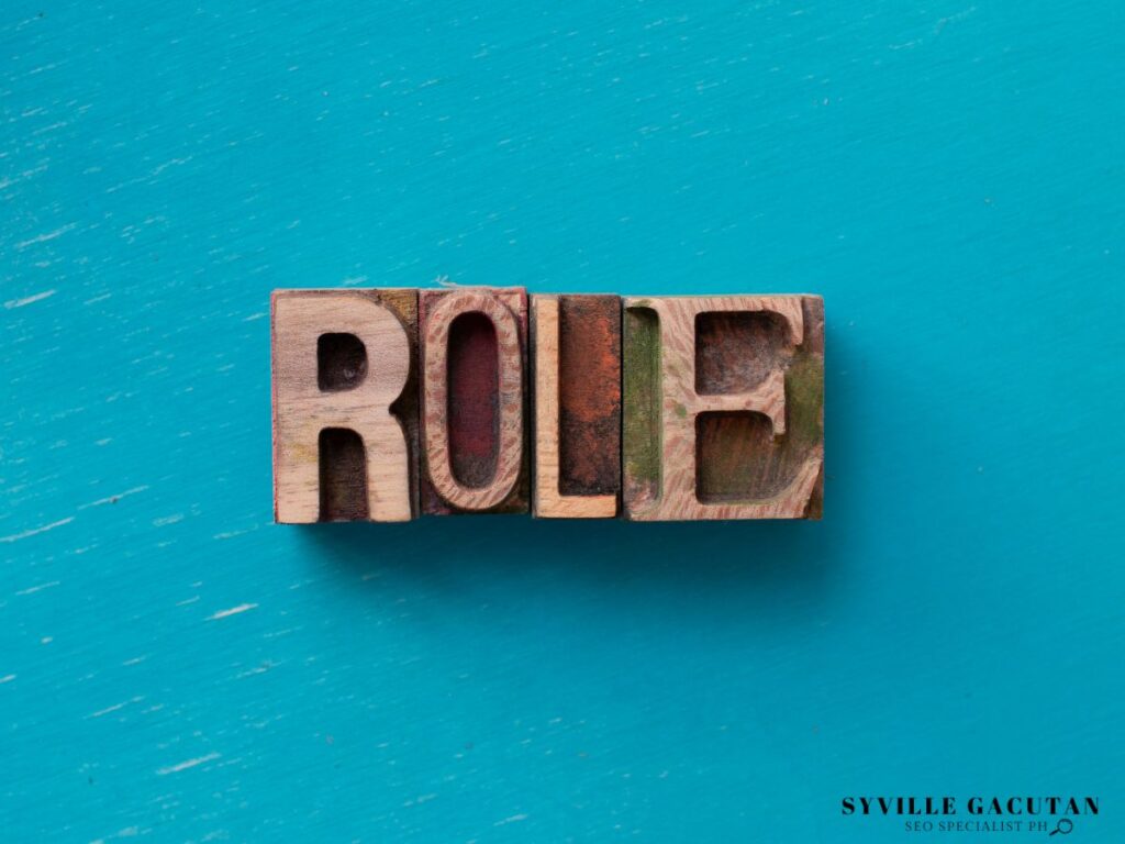 Vintage wooden letterpress spelling "ROLE" on turquoise blue background.