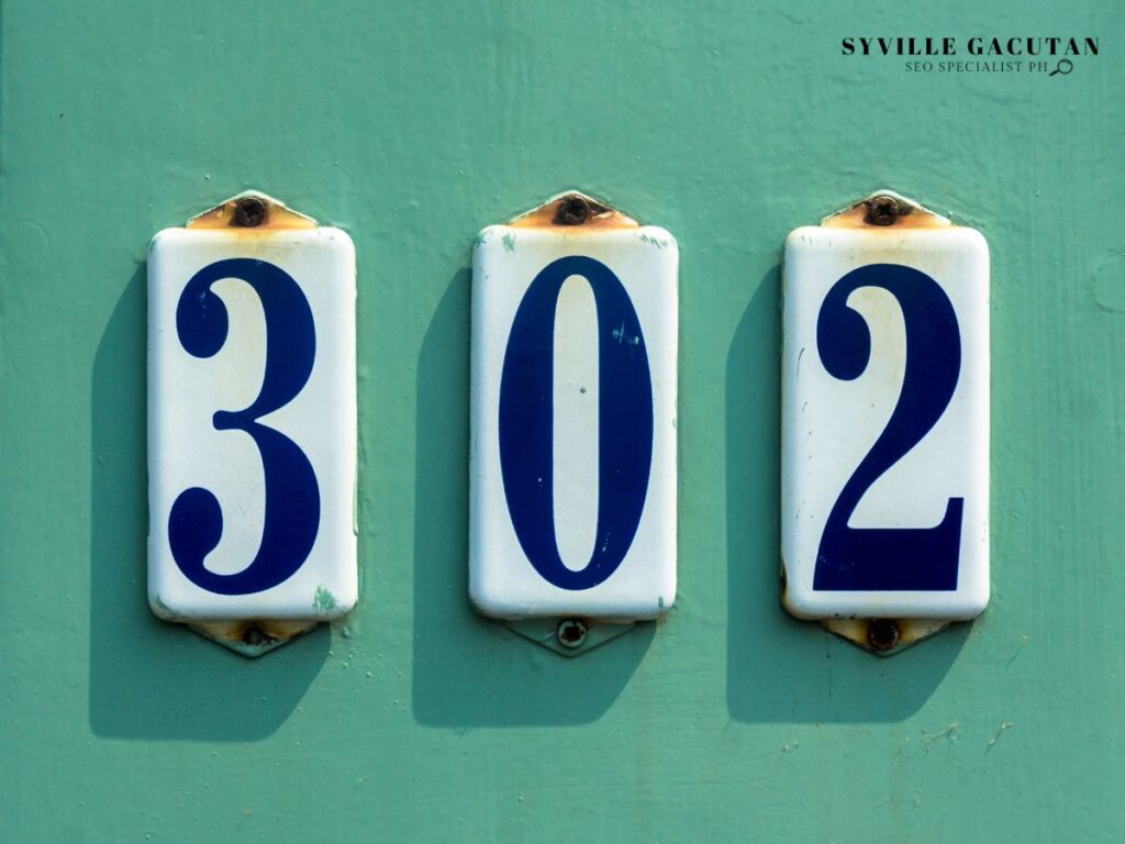 House number "302" in blue digits on white plates against mint green wall.