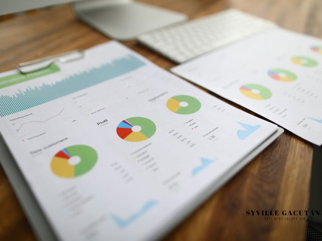 Financial charts on paper with colorful pie graphs on a desk.