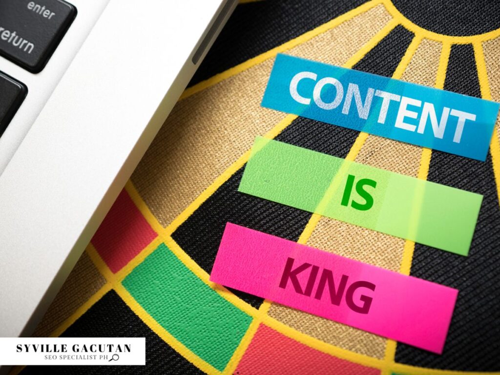 Sticky notes reading "Content Is King" beside a laptop.