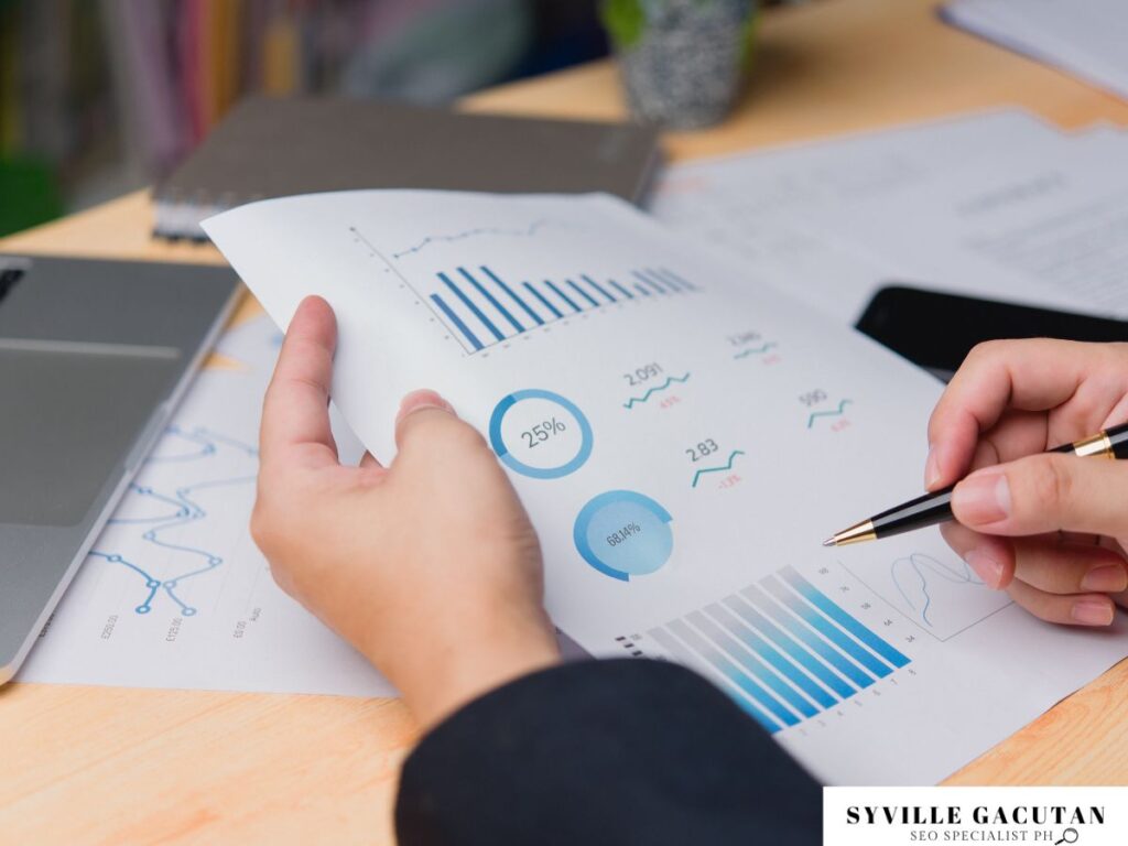 Hand holding a page of charts and data analysis.