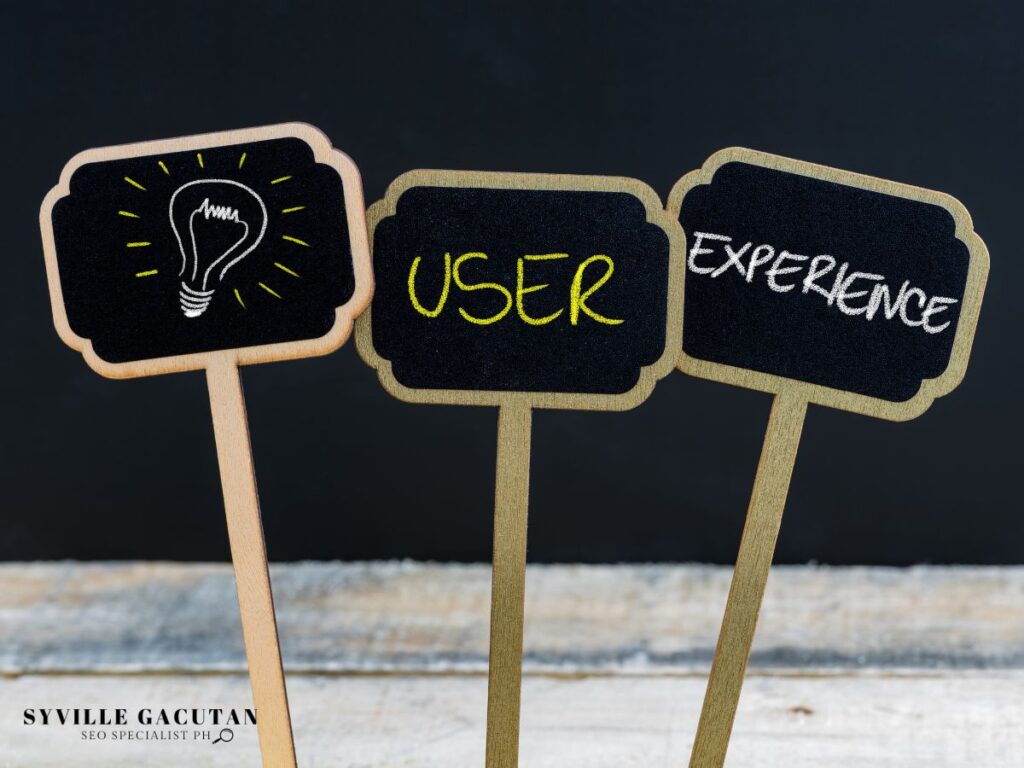 Three small chalkboard signs showing lightbulb icon, "USER", and "EXPERIENCE" text.