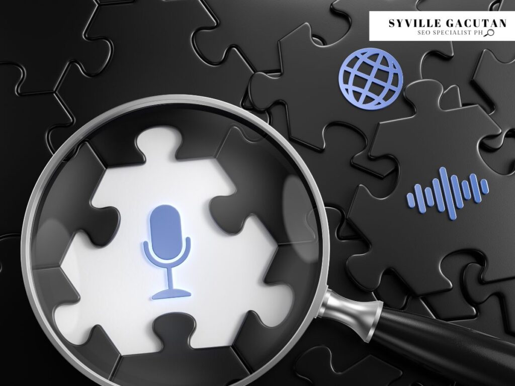 Magnifying glass focusing on a microphone icon on puzzle pieces.