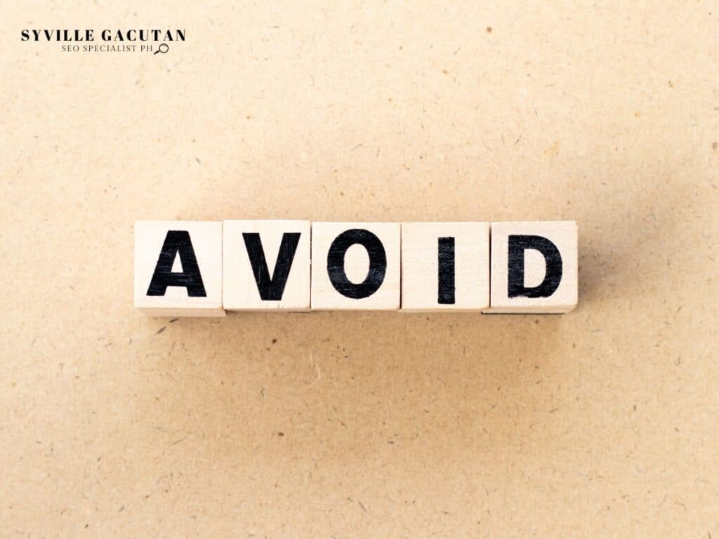 White wooden blocks spelling "AVOID" on a beige textured background.