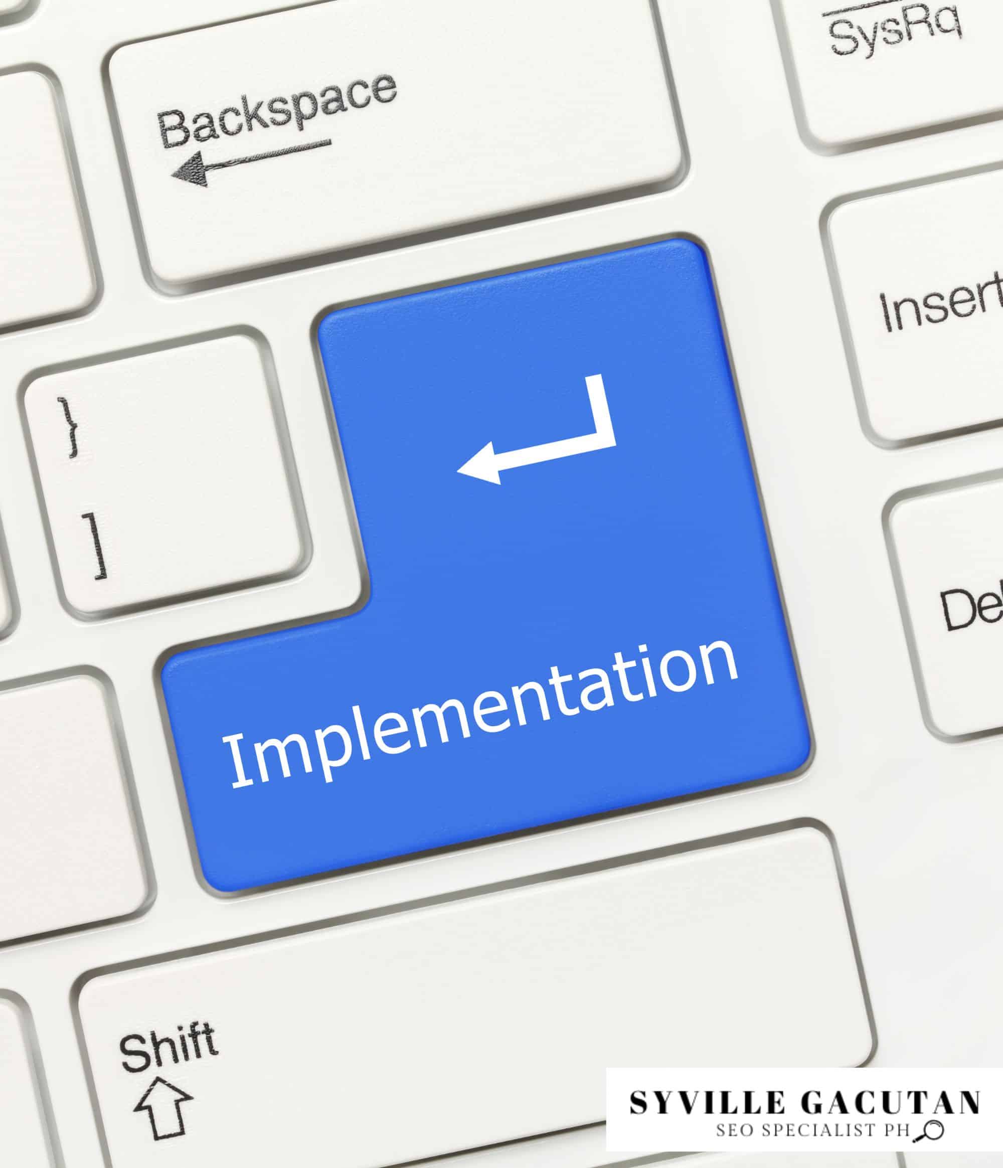 A blue keyboard key labelled "Implementation" for focus and execution.