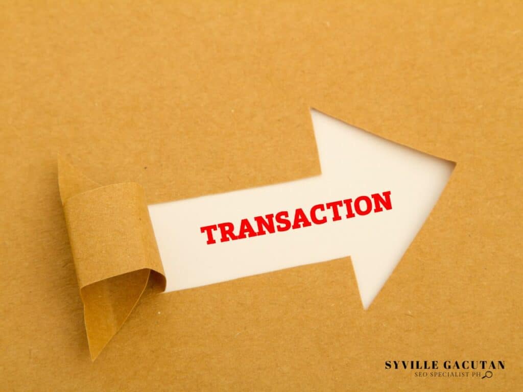 Brown paper torn to reveal white arrow with red text "TRANSACTION" pointing right.