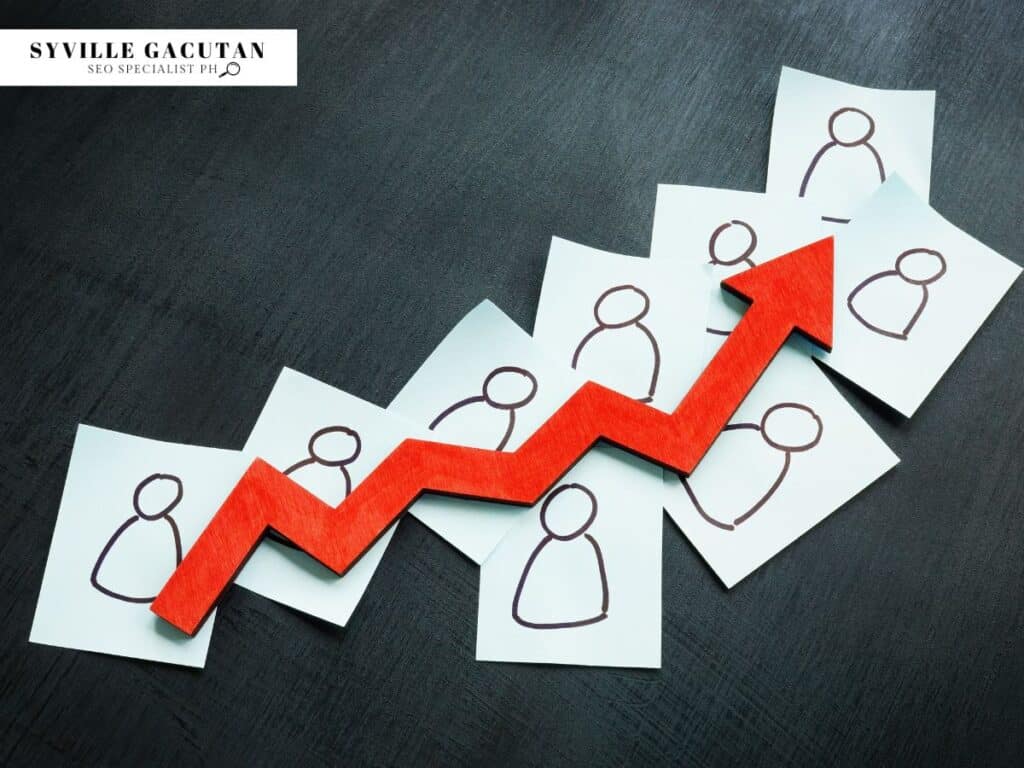 Red upward arrow placed over drawn icons of people, symbolising growth or engagement.