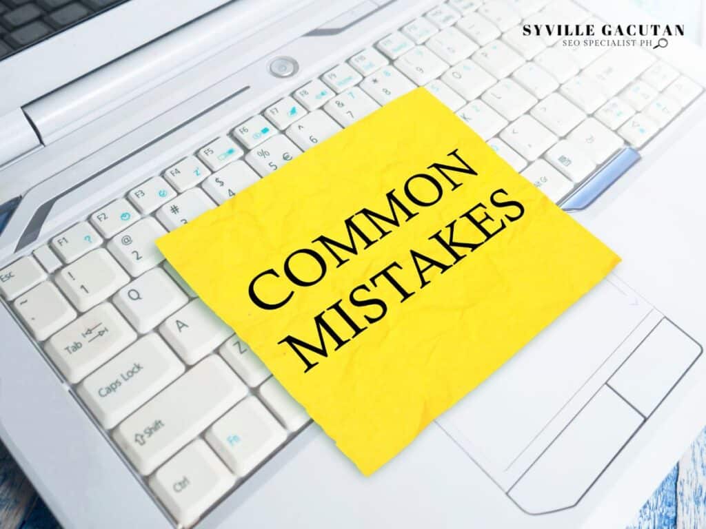 Yellow sticky note reading "COMMON MISTAKES" placed on white computer keyboard.