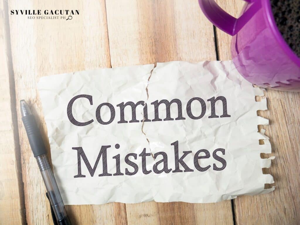 Crumpled paper with "Common Mistakes" text, pen and purple mug on wooden surface.