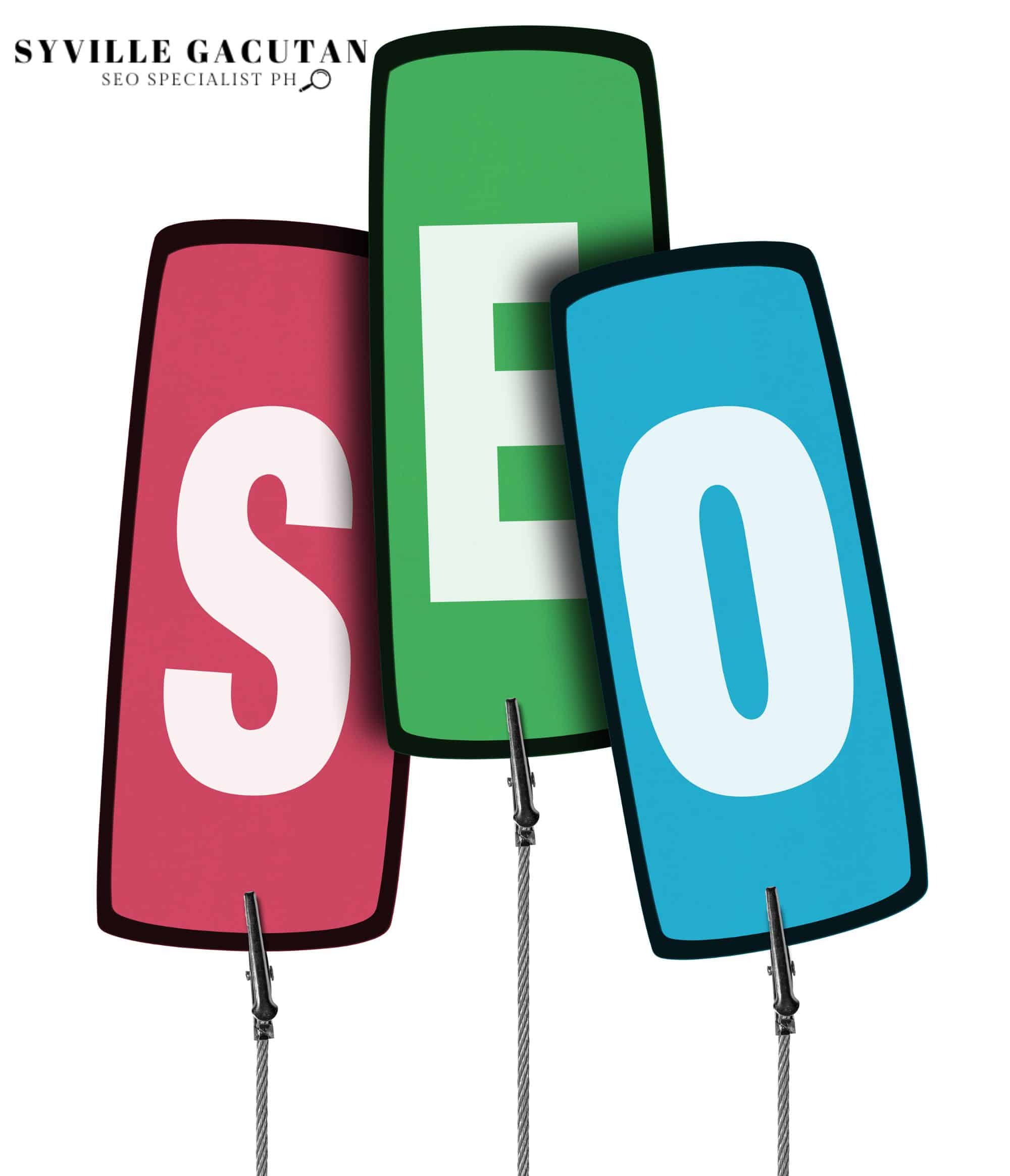 A "SEO" text display with three vertical panels in red, green, and blue mounted on metal stands.