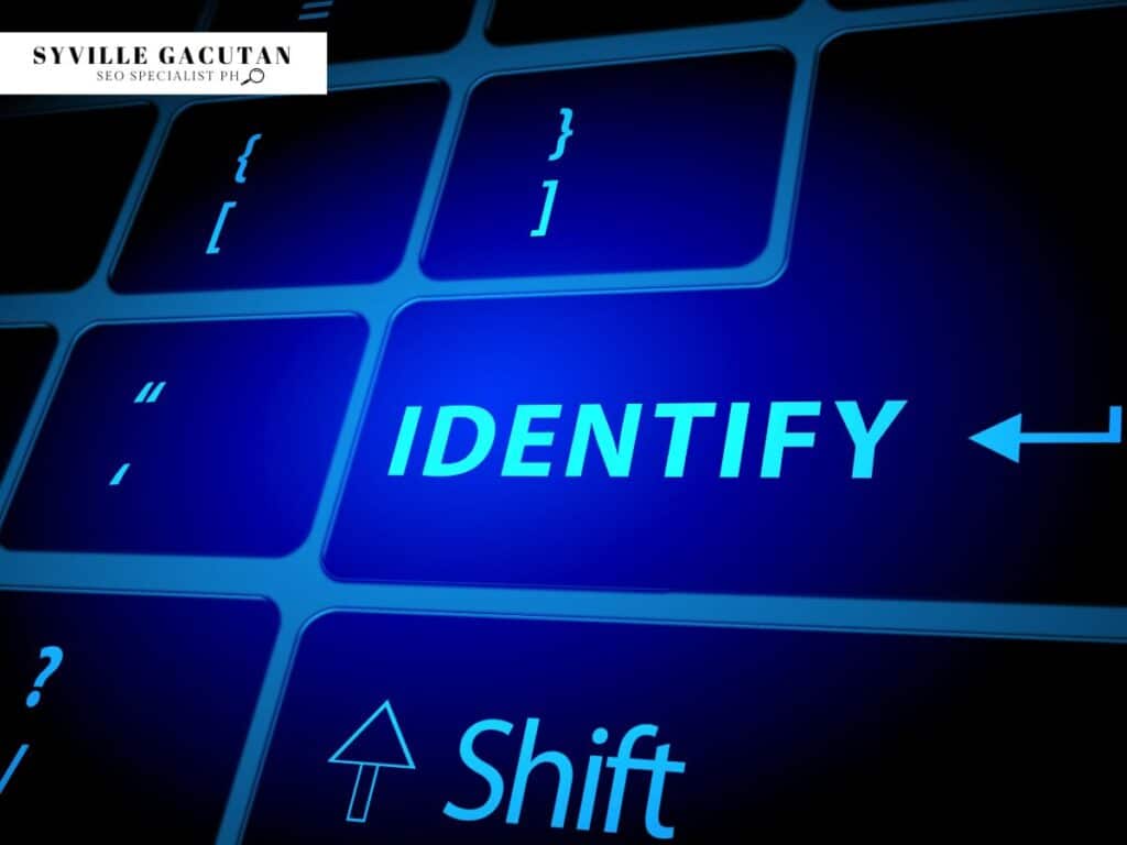 Blue illuminated keyboard key showing "IDENTIFY" with Shift key visible, dark background.