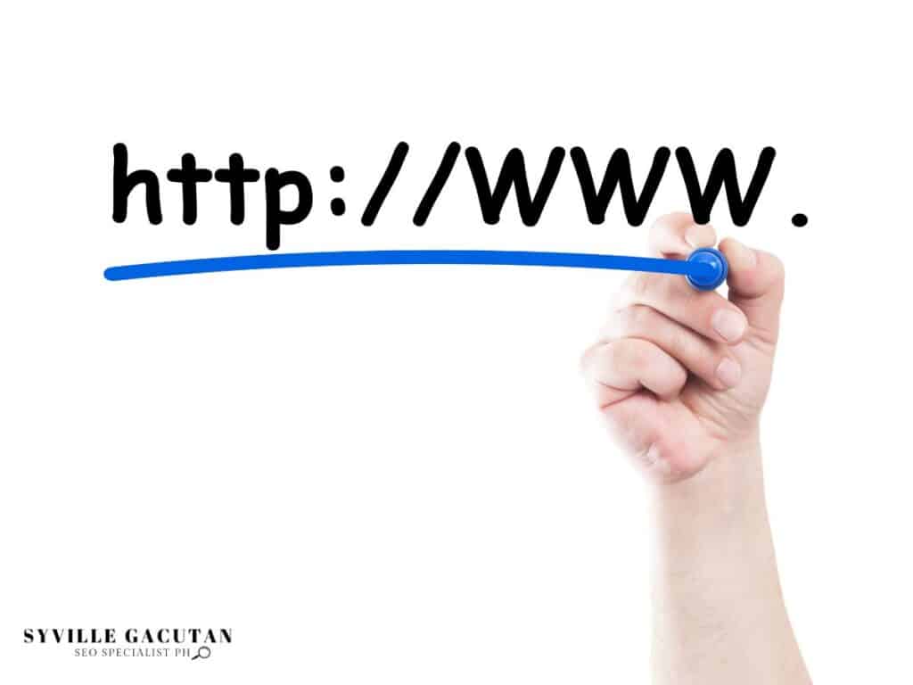 Hand writing "http://www" with blue marker, emphasizing web address structure.