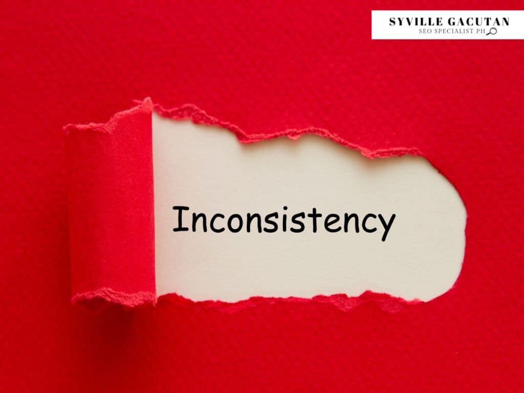 Red background with "Inconsistency" revealed under torn paper.