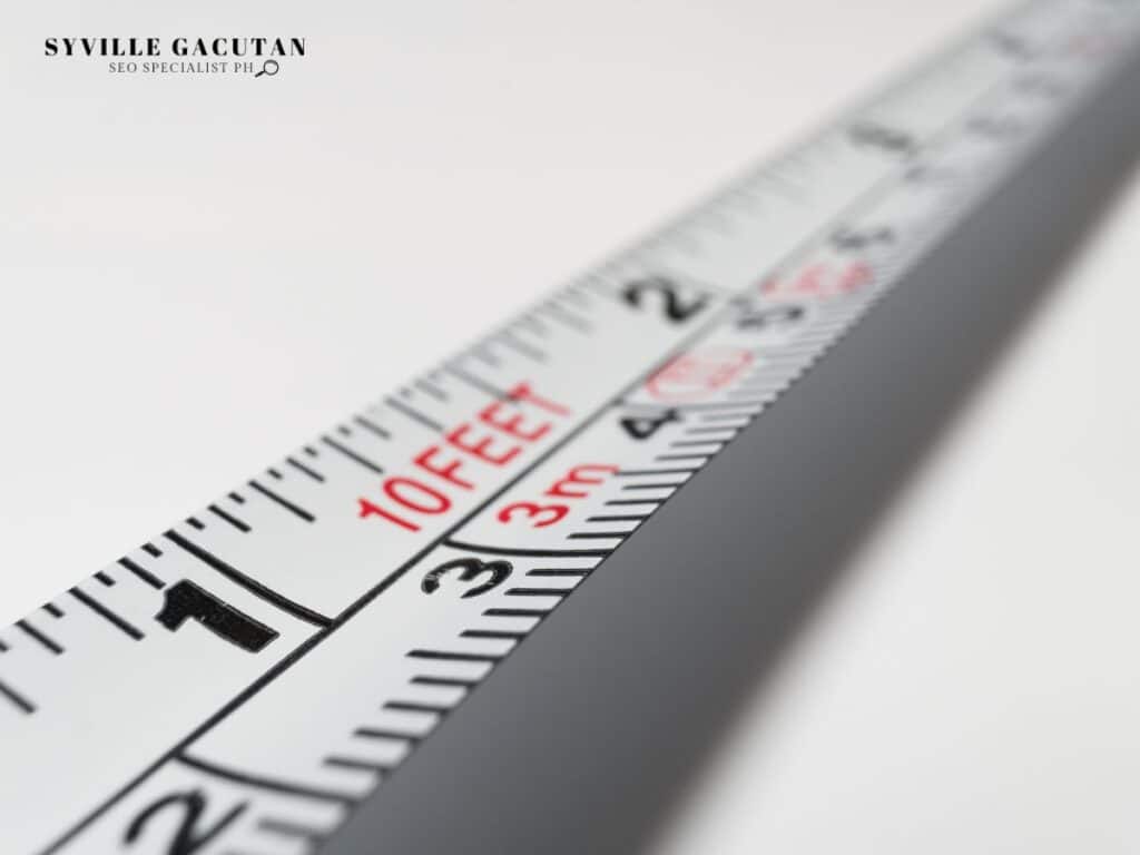 Close-up of measuring tape showing 10 feet mark, crisp detail in black and red.