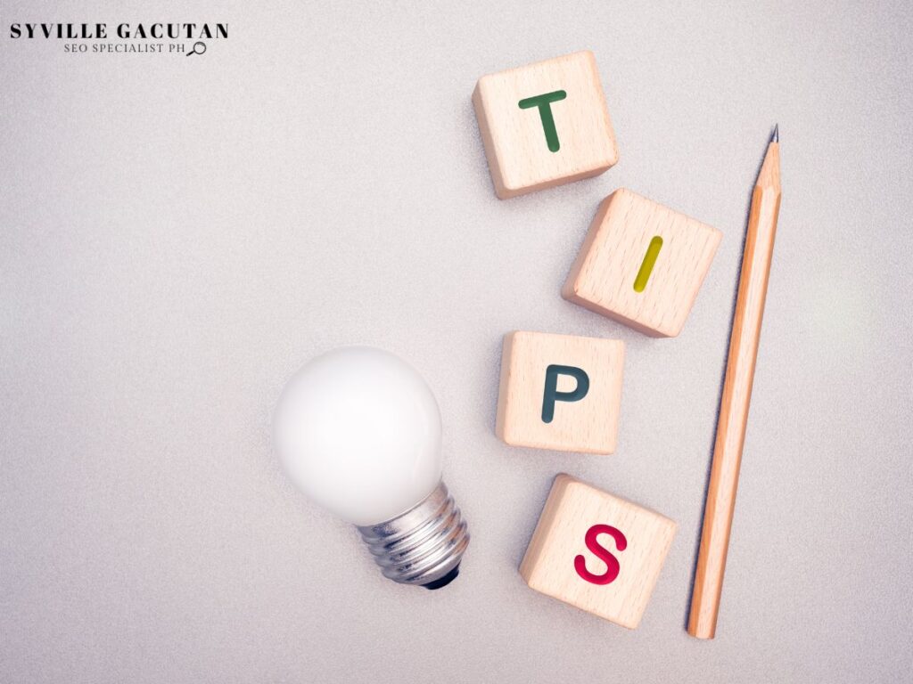 Wooden letter blocks spelling "TIPS" with lightbulb and pencil on gray background.