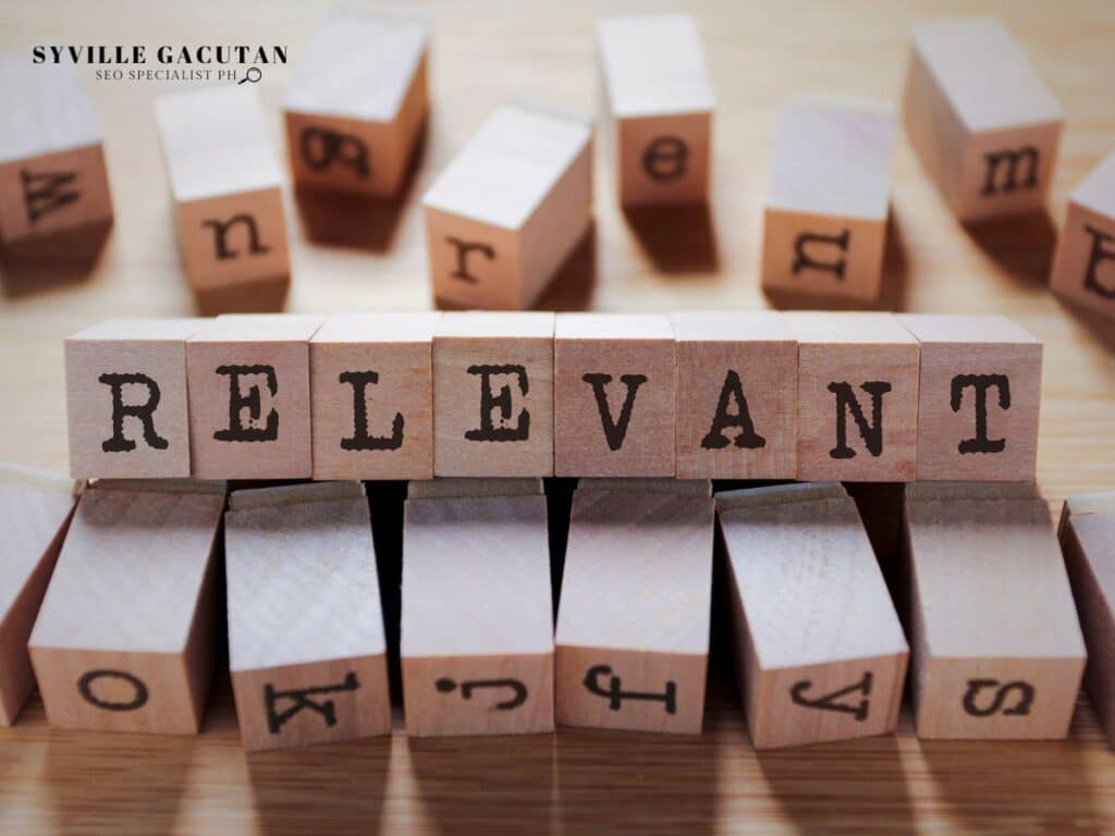 Wooden letter blocks spelling "RELEVANT" with scattered alphabet blocks in background.
