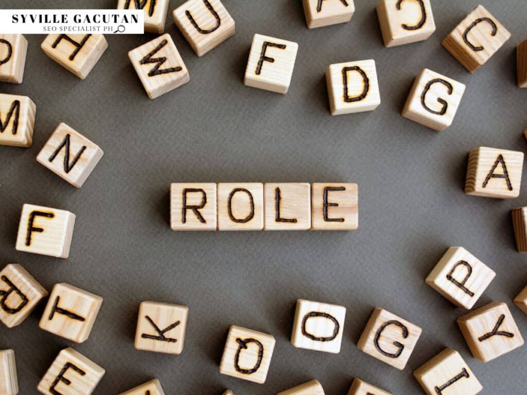 Wooden blocks spelling "ROLE," surrounded by scattered letter blocks.
