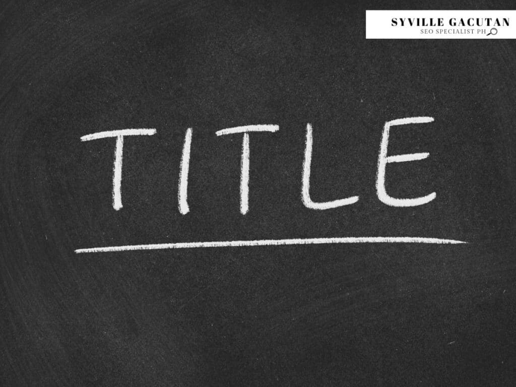 Word "TITLE" written in white chalk on black chalkboard with underline.