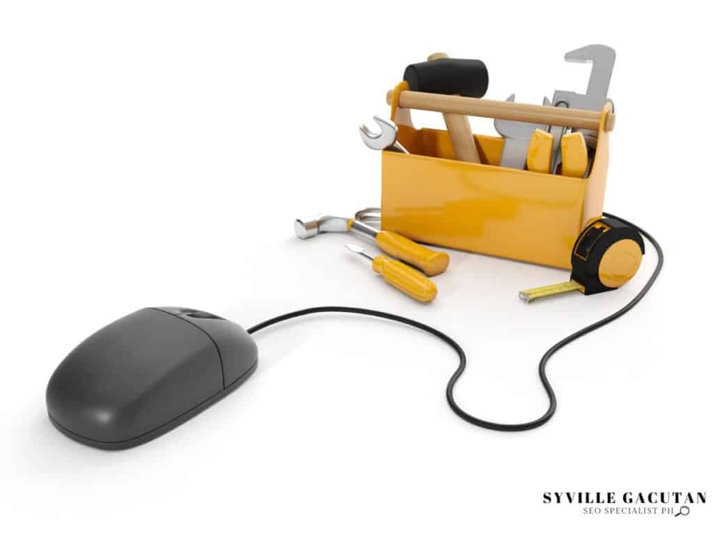 Computer mouse connected to yellow toolbox with wrenches and tools on white background.