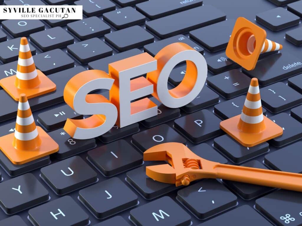 SEO text with orange traffic cones and wrench on computer keyboard.