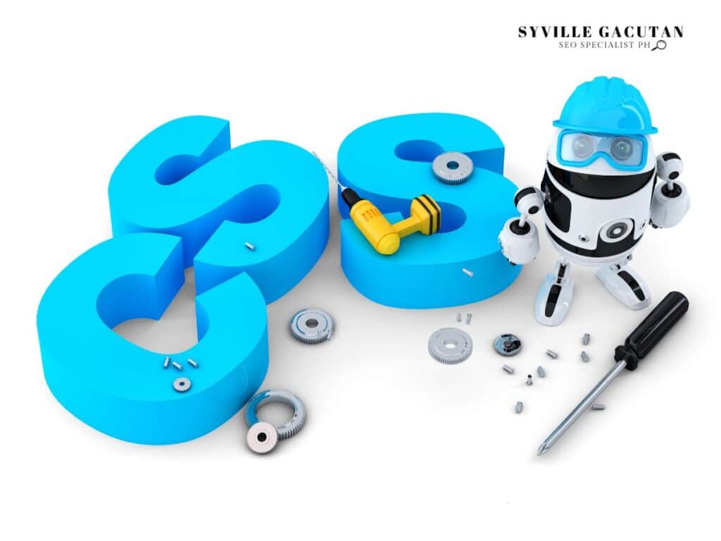 3D blue CSS letters with robot mechanic and repair tools scattered around.