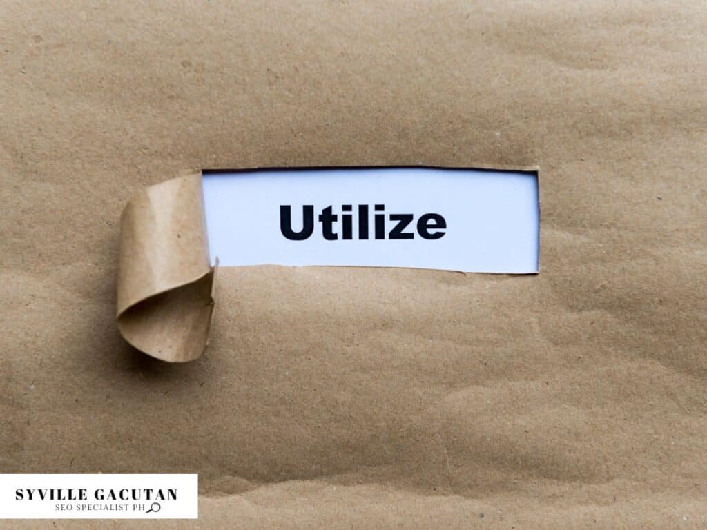 The word "Utilize" revealed under torn brown paper.