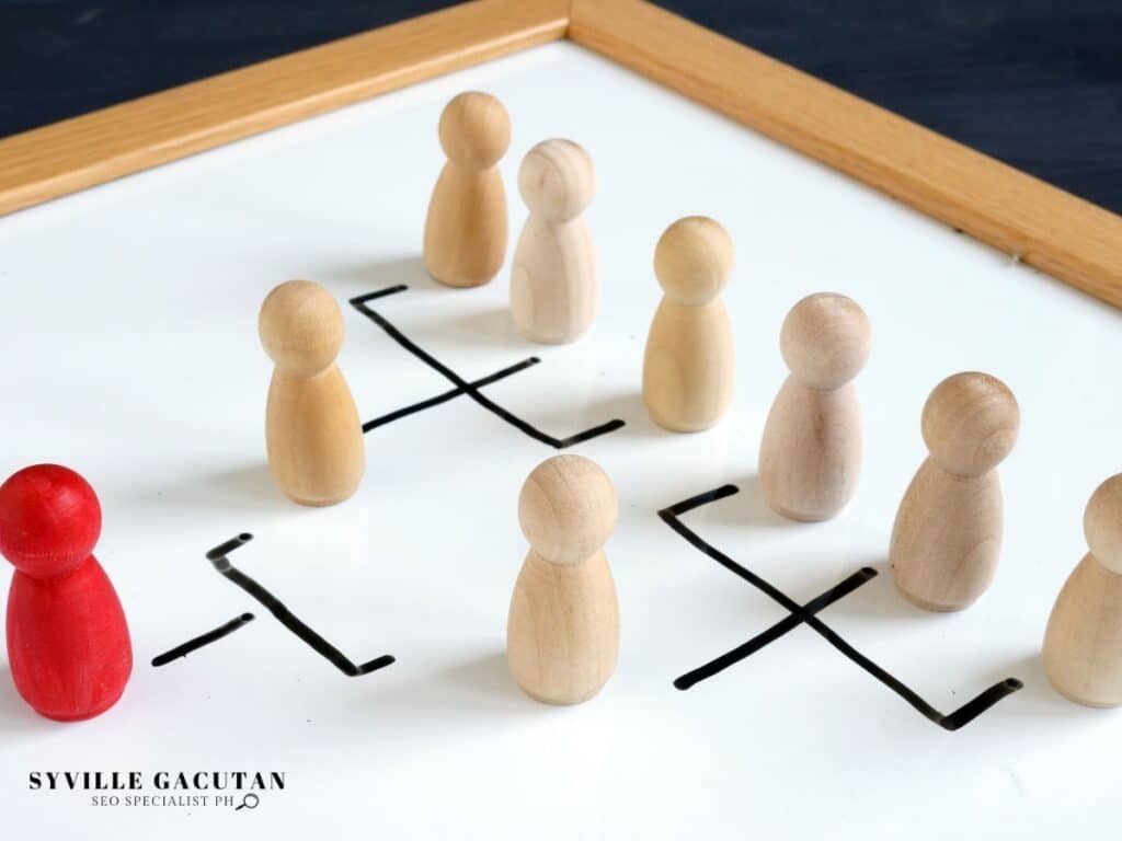 Wooden figures arranged in organizational hierarchy with connecting lines.