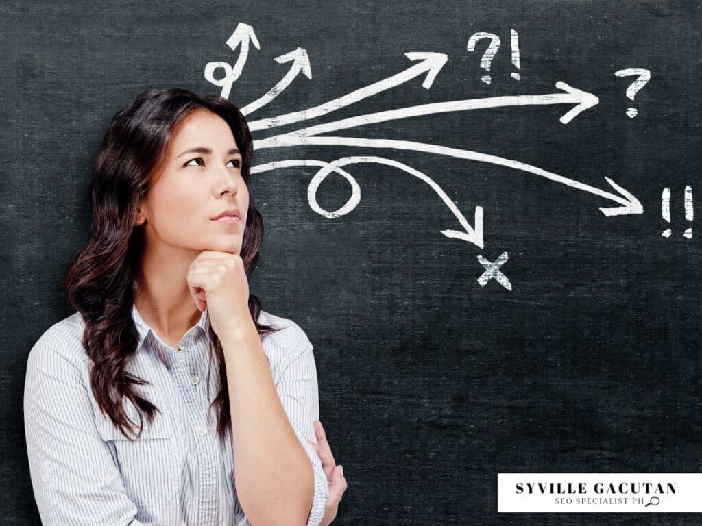 Woman thinking with arrows and symbols on a chalkboard background.