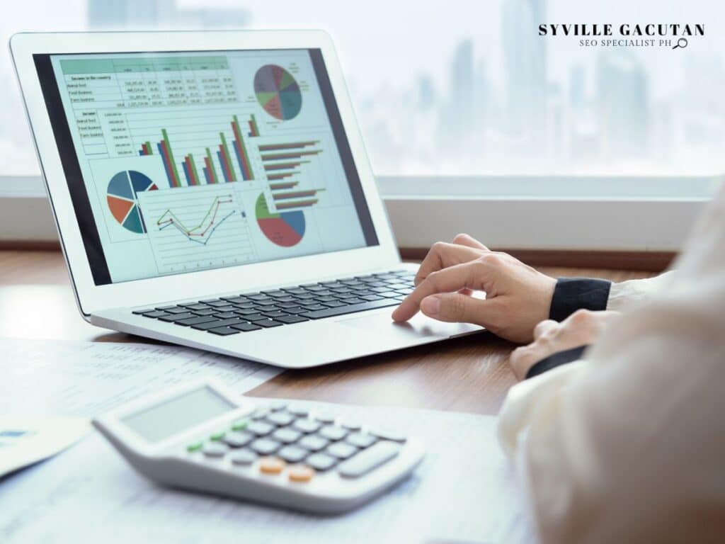Person analyzing colorful charts and graphs on a laptop screen.

