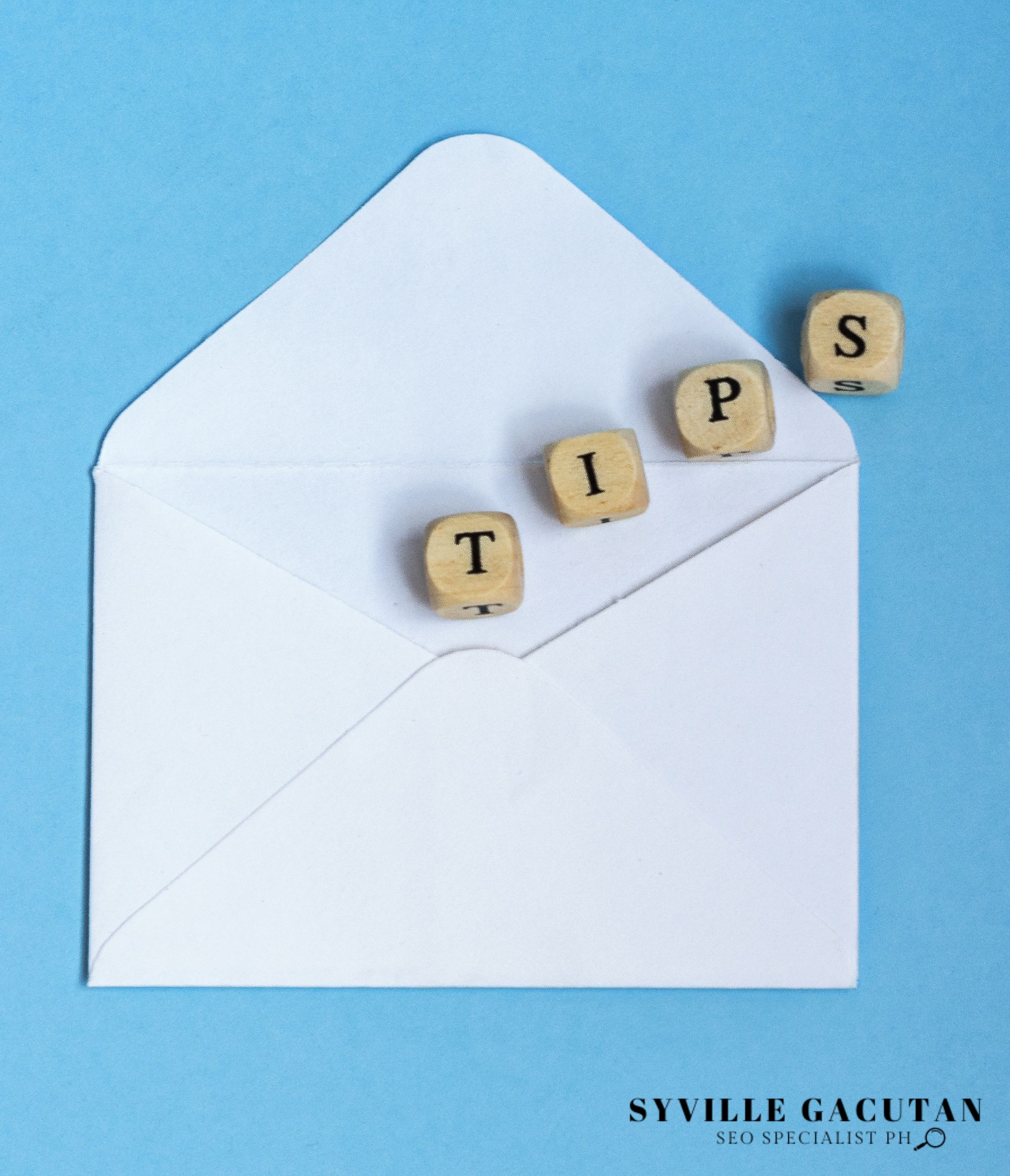 White envelope with a wooden blocks spelled as "TIPS"