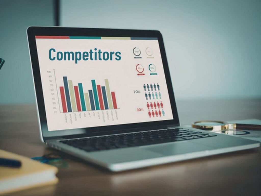 Laptop screen showing competitor analysis charts.