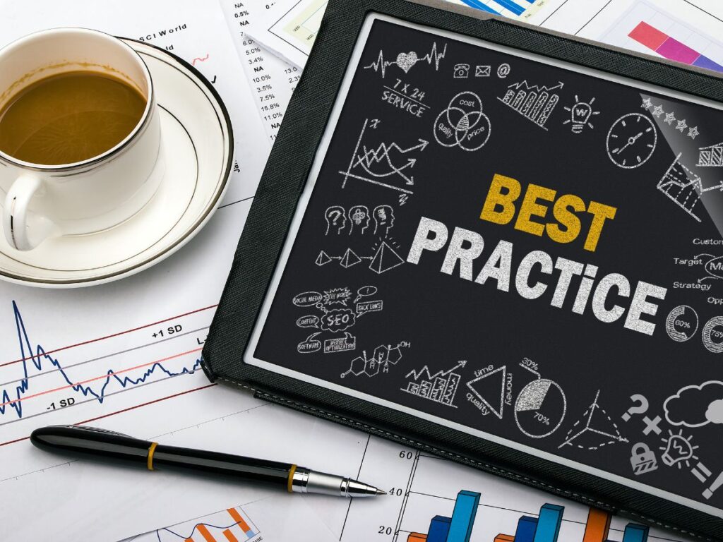Best practice tablet beside charts and coffee.
