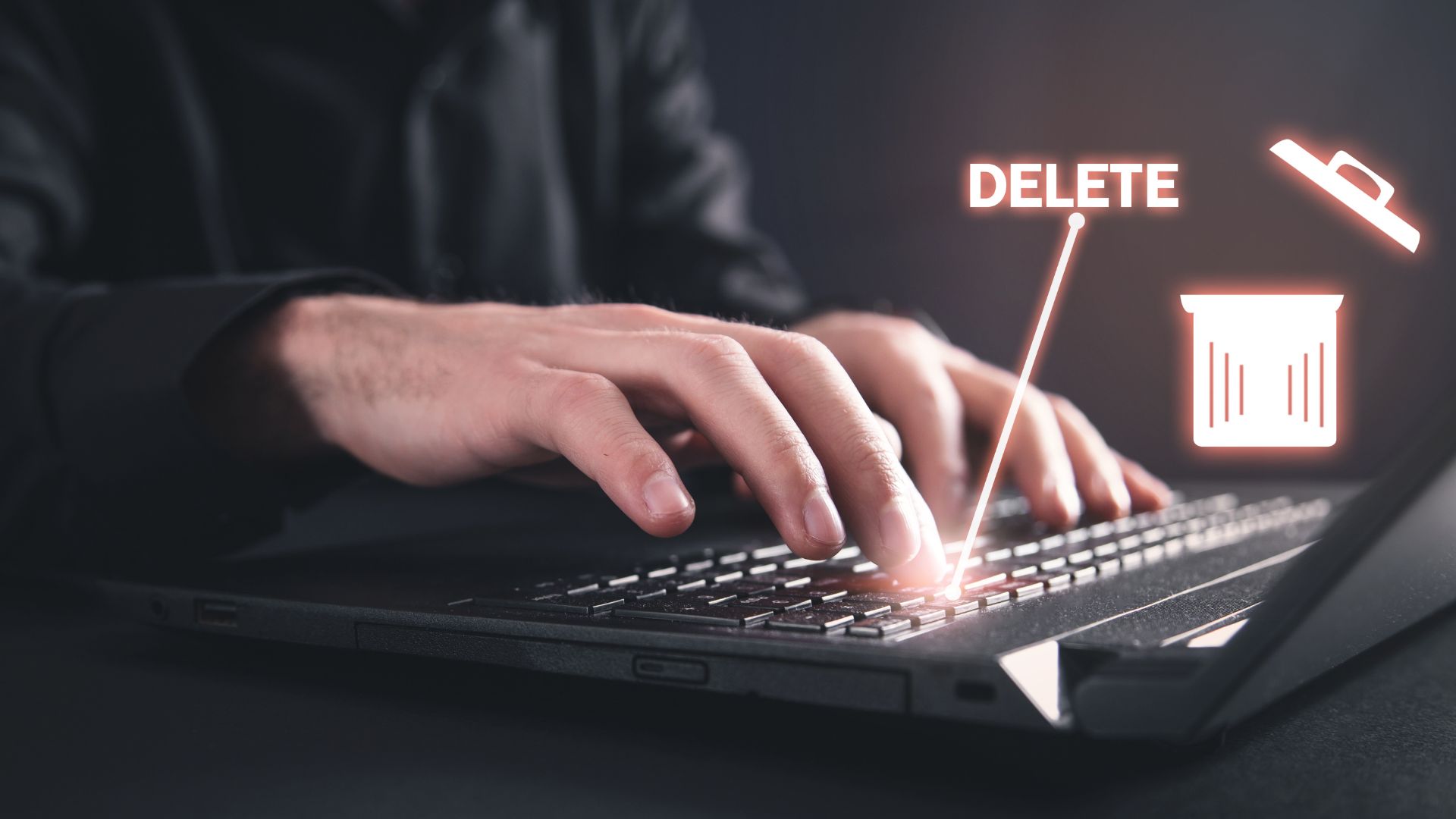 Laptop keyboard with glowing delete icon.
