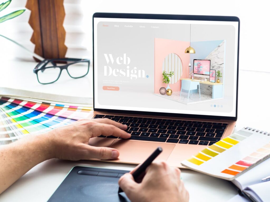 Designer working on a web design layout with color swatches.