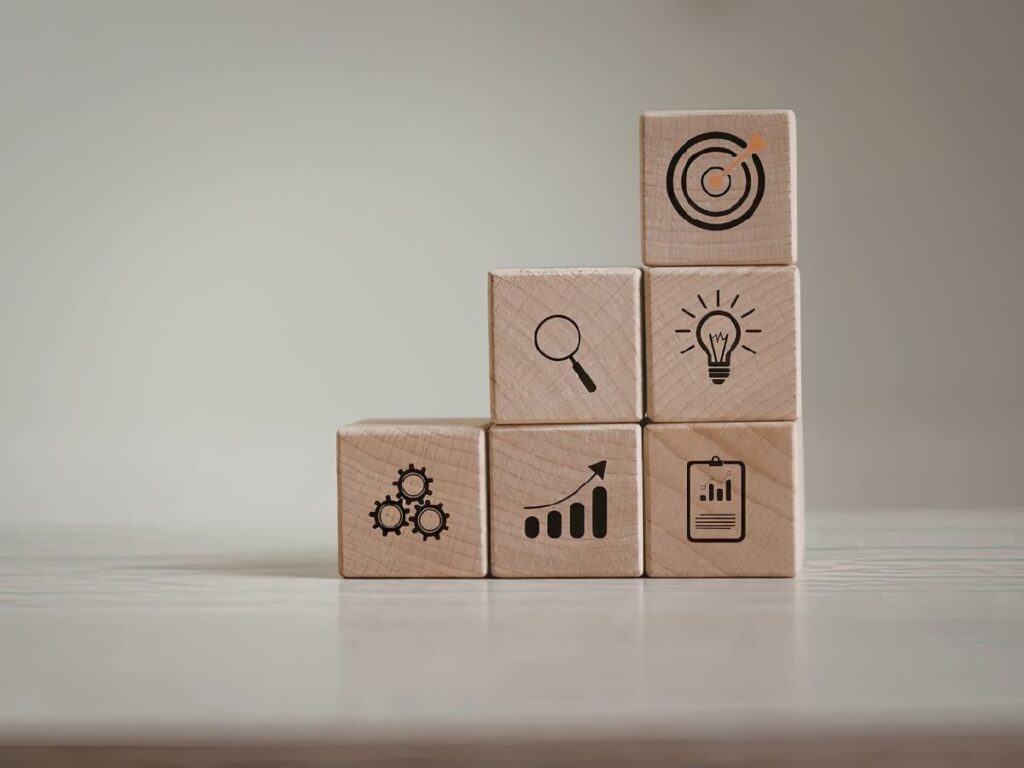 Wooden blocks showing SEO strategy icons.