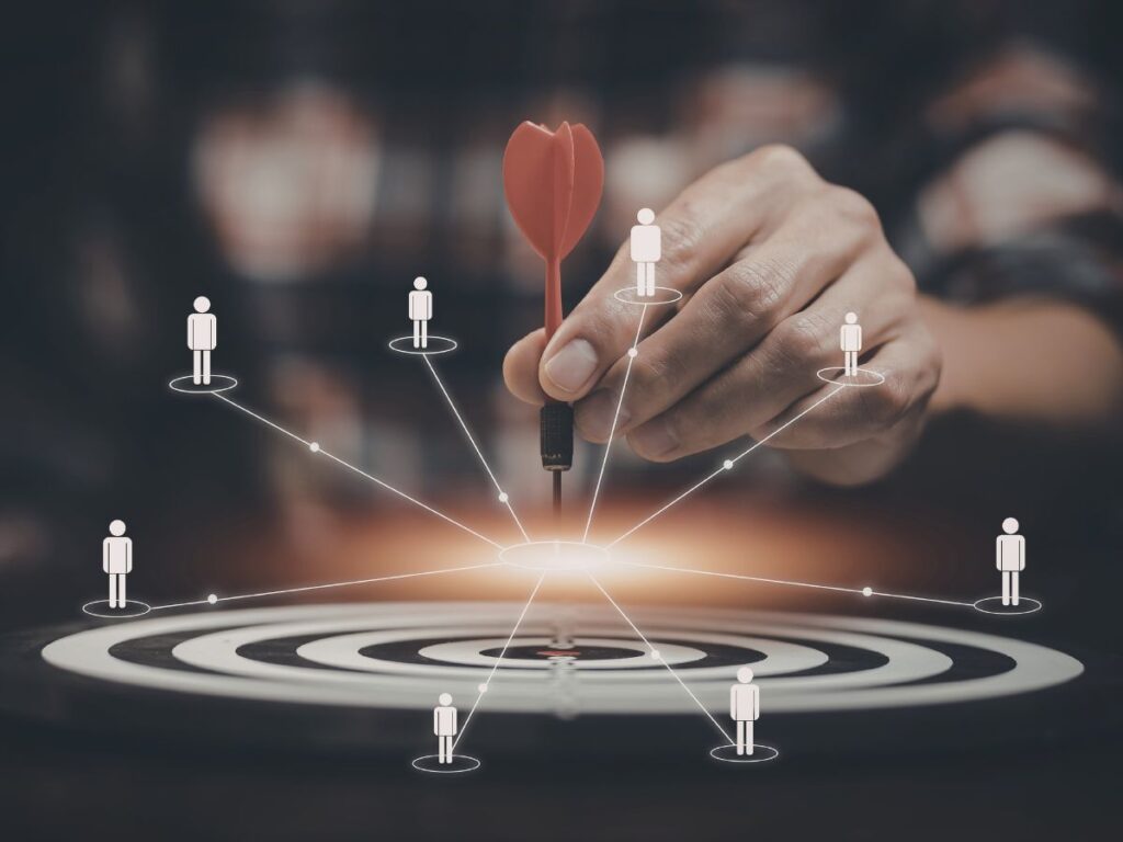 Dart hitting a target with user icons.