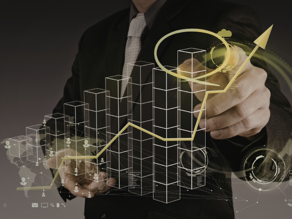 Businessman drawing a rising digital chart and growth arrow.