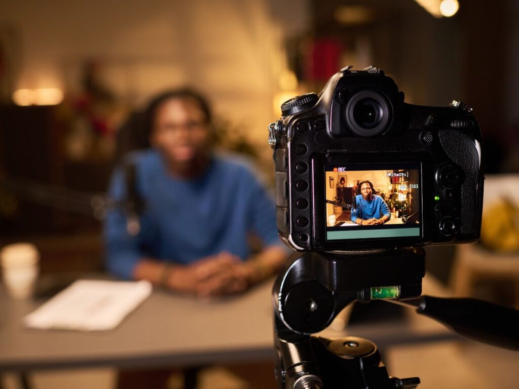 Camera recording a person speaking for video content.